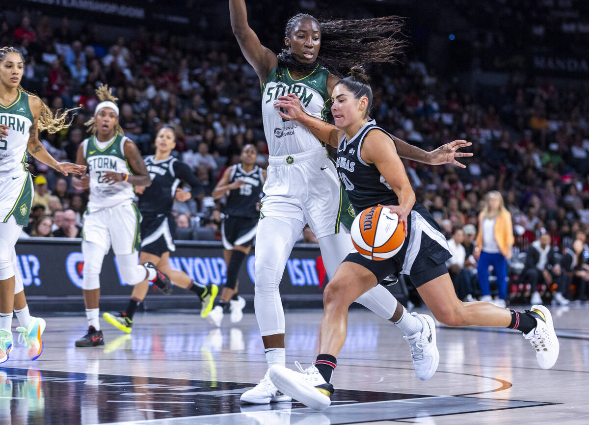 Aces guard Kelsey Plum (10) drives the lane again st Seattle Storm center Ezi Magbegor (13) dur ...