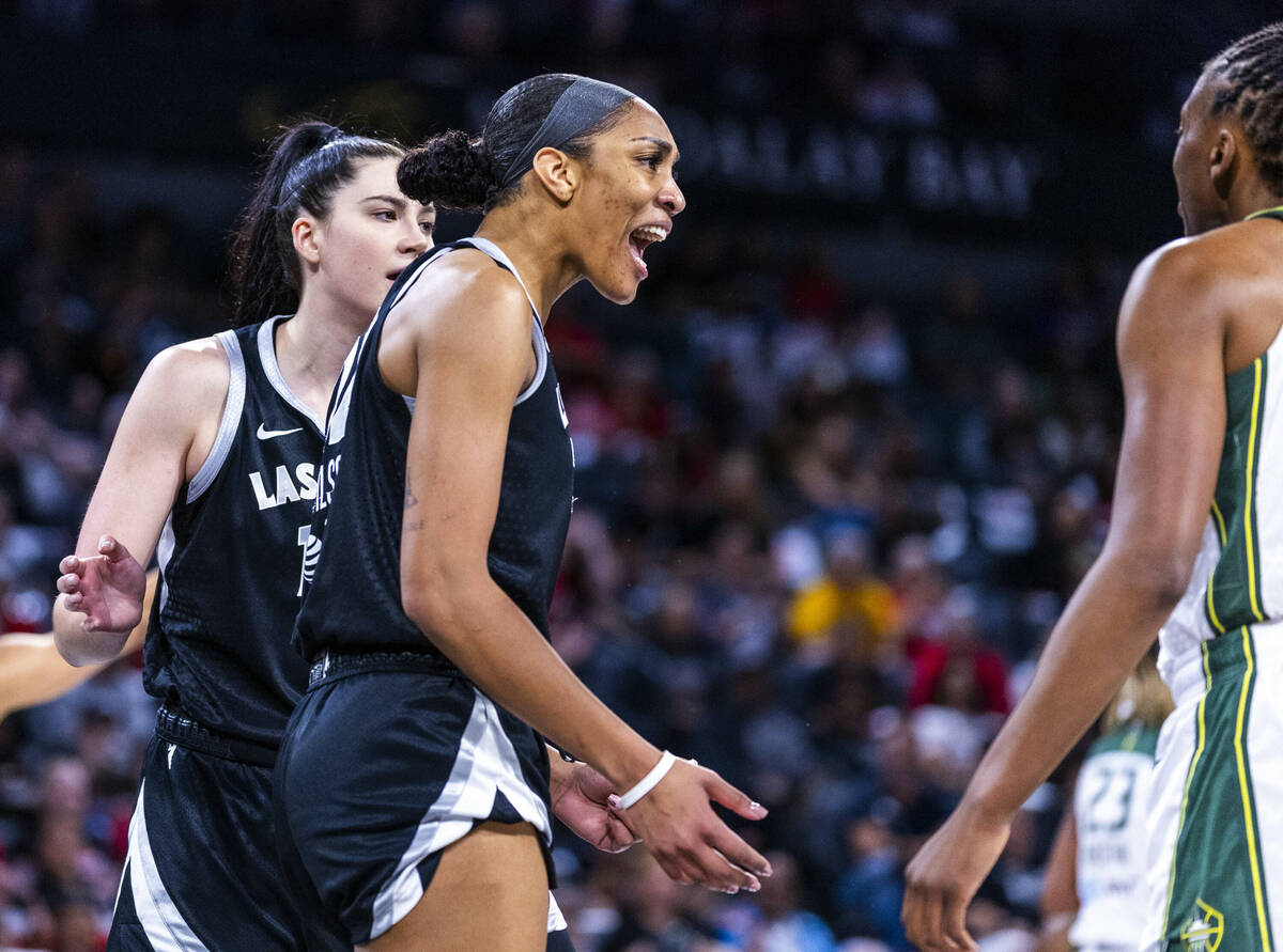 Aces center A'ja Wilson (22) yells about being fouled on the drive by Seattle Storm guard Jorda ...