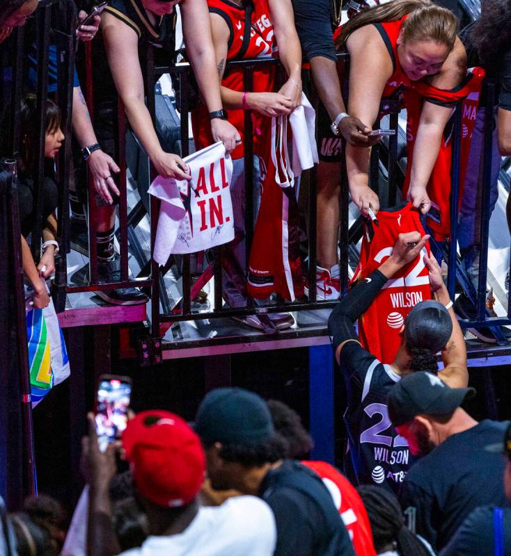 Aces center A'ja Wilson (22) signs autographs following the win over the Seattle Storm in their ...