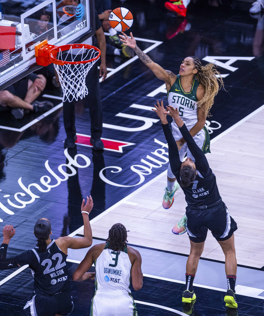 Seattle Storm forward Gabby Williams (5) gives over the top of Aces forward Alysha Clark (7) fo ...