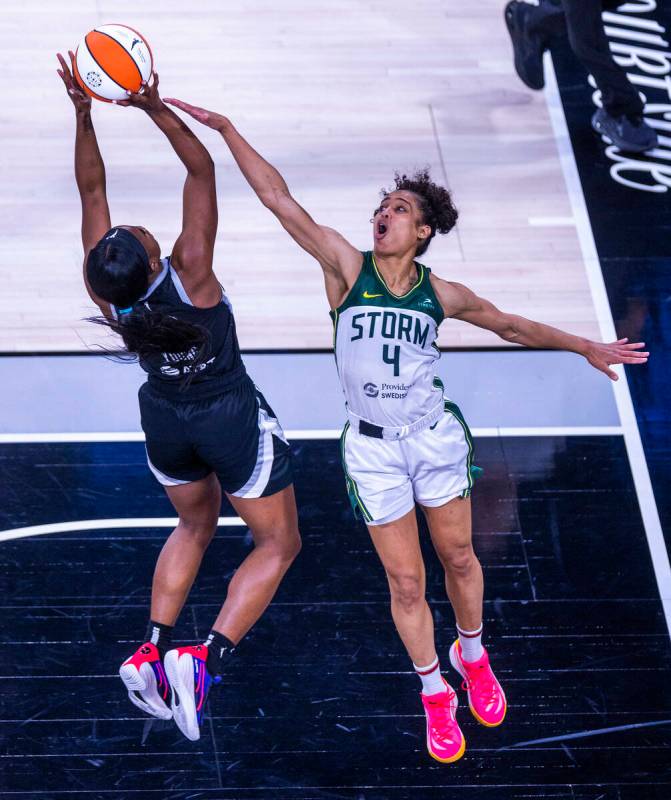 Aces guard Jackie Young (0) gets off. shot as Seattle Storm guard Skylar Diggins-Smith (4) near ...