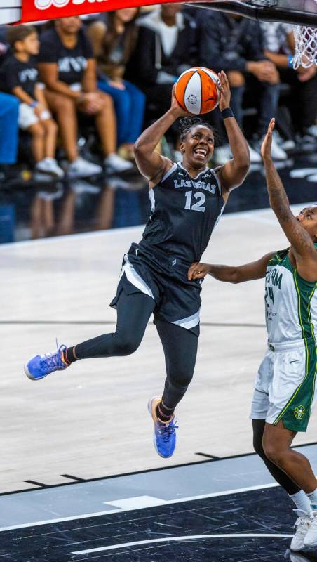 Aces guard Chelsea Gray (12) elevates to score late against Seattle Storm guard Jewell Loyd (24 ...