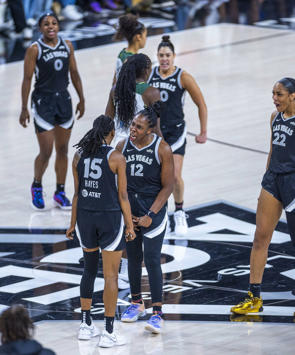 Aces guard Tiffany Hayes (15) is congratulated by guard Chelsea Gray (12) and center A'ja Wilso ...