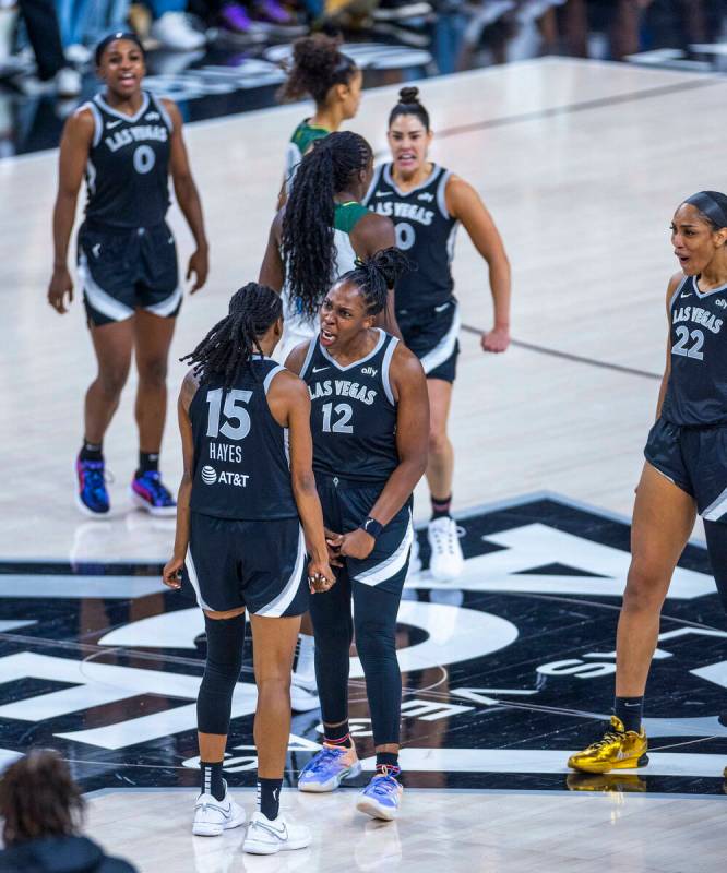 Aces guard Tiffany Hayes (15) is congratulated by guard Chelsea Gray (12) and center A'ja Wilso ...