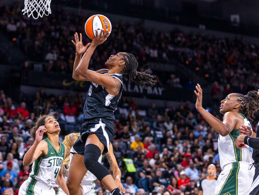 Aces guard Tiffany Hayes (15) gets to the hoop over Seattle Storm guard Skylar Diggins-Smith (4 ...