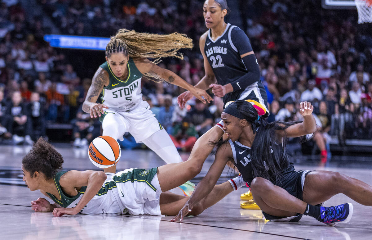 Aces guard Jackie Young (0) loses the ball after a double team by Seattle Storm guard Skylar Di ...