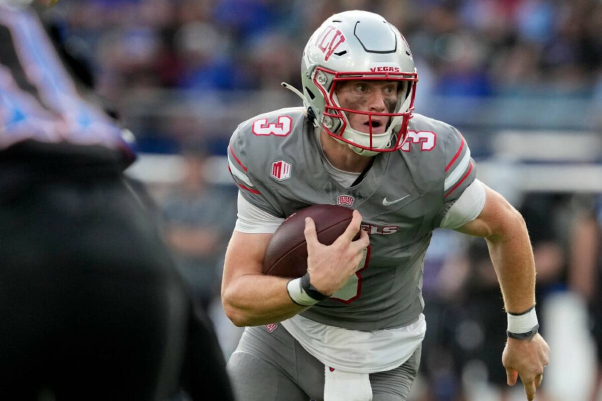 UNLV quarterback Matthew Sluka runs with the ball in the first half against Kansas during an NC ...