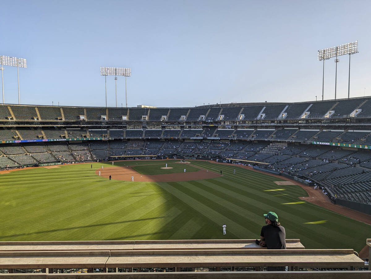 A fan standing in left field during a sparsely attended game between the Oakland A's and Colora ...