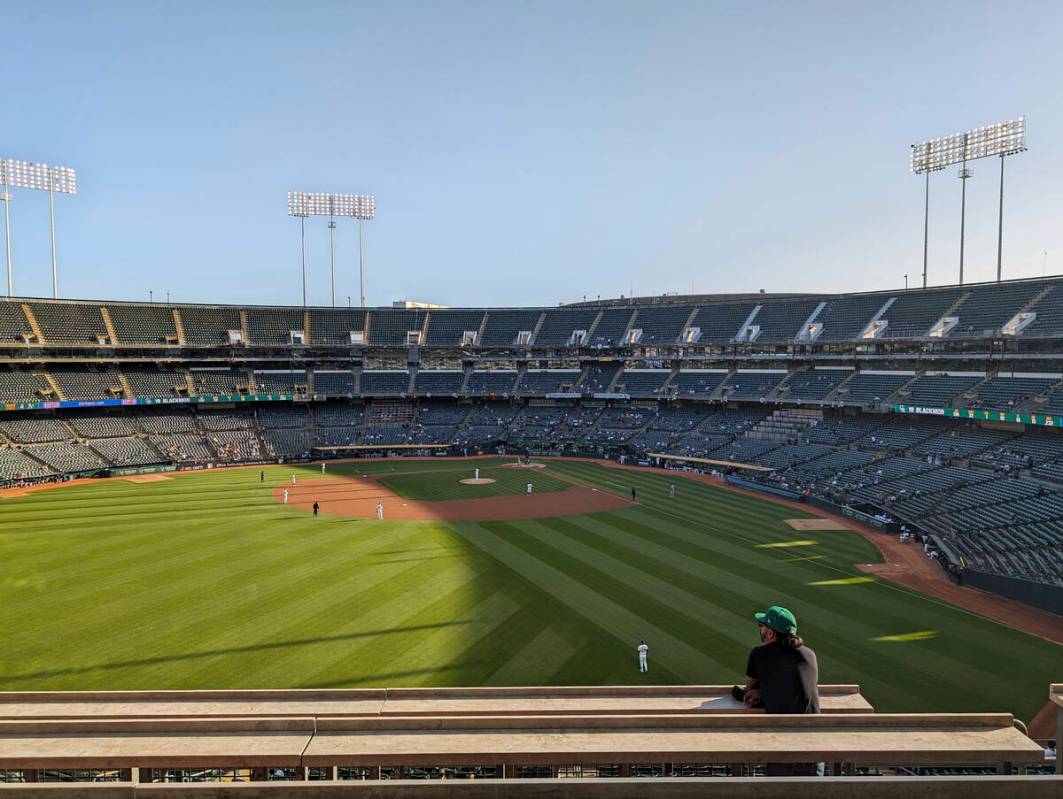 A fan standing in left field during a sparsely attended game between the Oakland A's and Colora ...