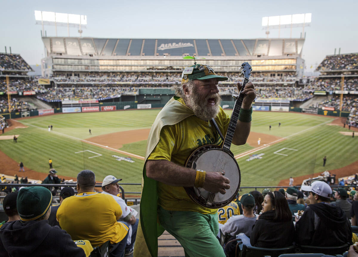 FILE - Oakland Athletics fan "Banjo Man" (aka Stacy Samuels) plays for the crowd in t ...