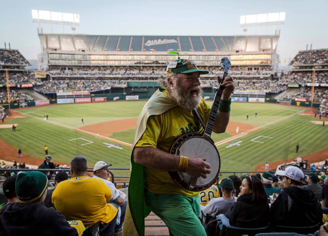 FILE - Oakland Athletics fan "Banjo Man" (aka Stacy Samuels) plays for the crowd in t ...