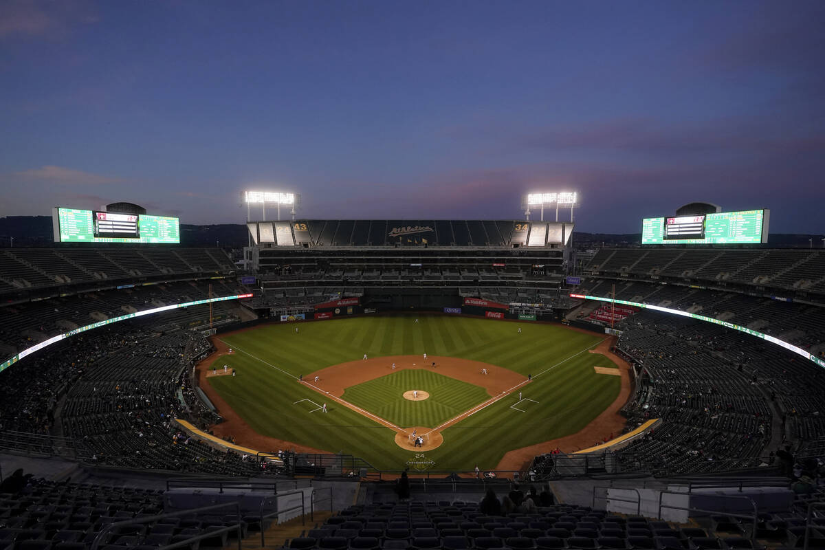 FILE - Fans at Oakland Coliseum watch a baseball game between the Oakland Athletics and the Cin ...