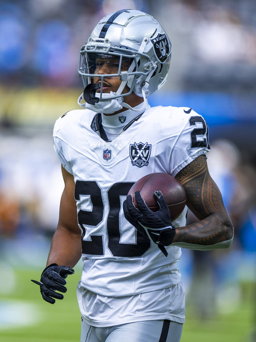 Raiders safety Isaiah Pola-Mao (20) runs with the ball as they warm up to face the Los Angeles ...