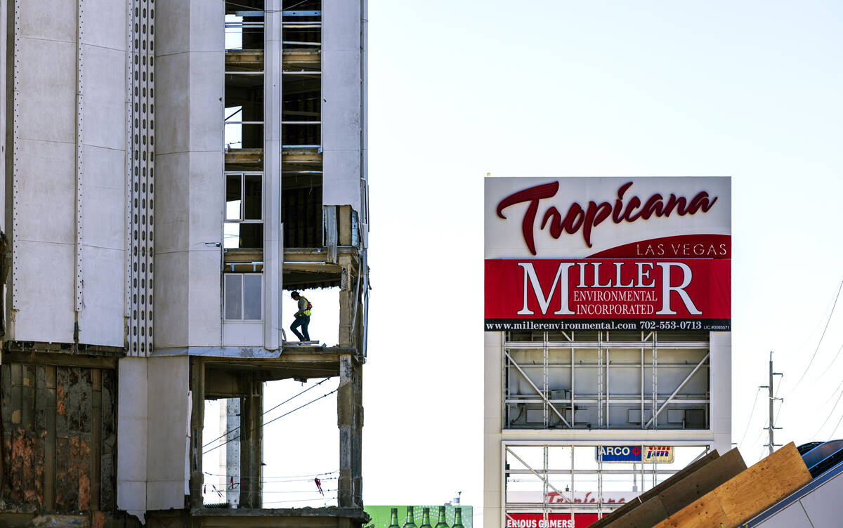 A construction crew worker walks about the front tower as preparations for the upcoming implosi ...