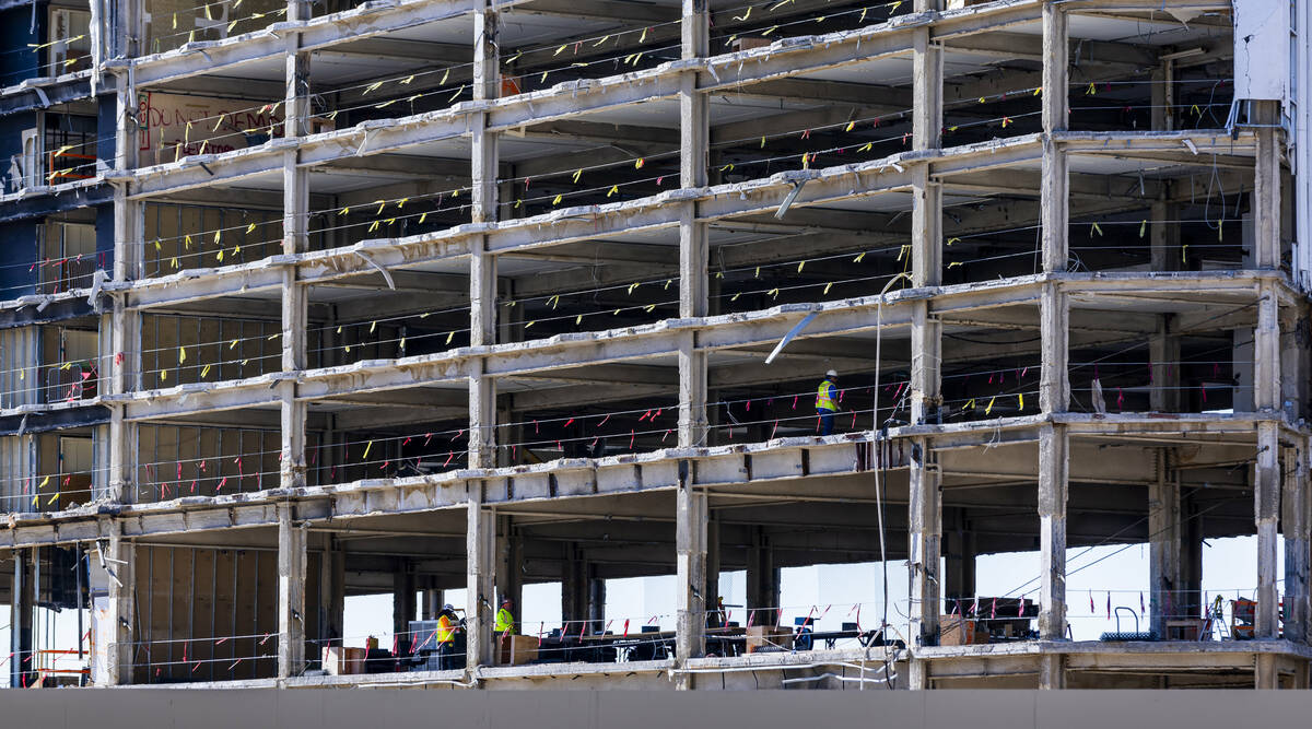 A construction crew works about the front tower as preparations for the upcoming implosion cont ...