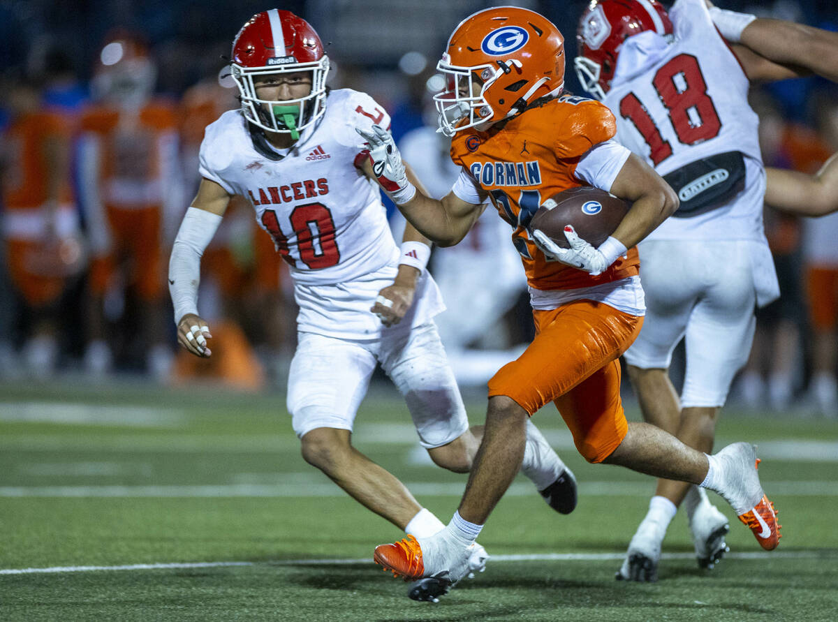 Bishop Gorman running back Myles Norman (24) looks to turn the corner on Orange Lutheran defens ...