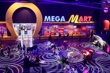 Visitors to Area 15 roam outside the Omega Mart on Thursday, July 11, 2024, in Las Vegas. (Las ...