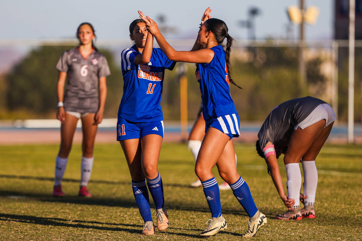 Bishop Gorman midfielder Devyn Giraldo (11) and teammate Alana Moore (9) celebrate a goal durin ...