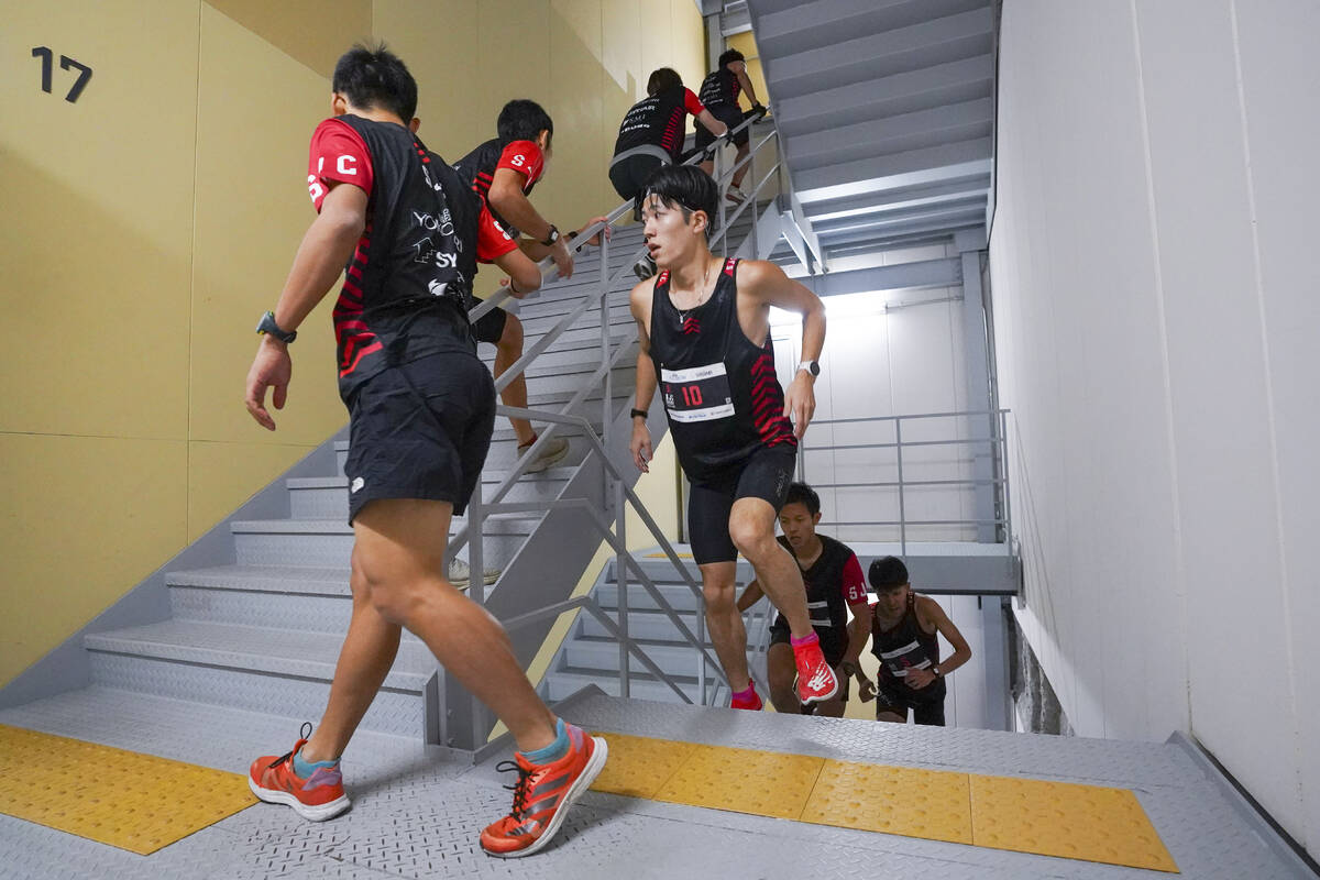 In this photo provided by ISF/Meeting, competitors climb stairs during a race of Stairclimbing ...