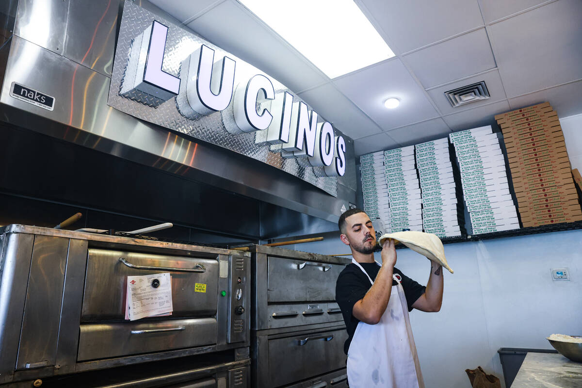 Owner Joey Scolaro tosses pizza dough at Lucino’s Pizza in Las Vegas, Thursday, Sept. 26, 202 ...