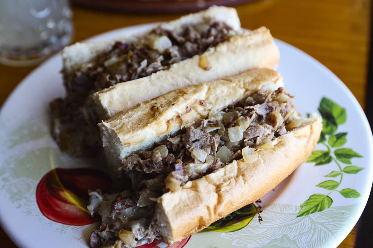 The Classic Philly Cheesesteak Sandwich on a Liscio's roll tossed with chopped fried onion and ...