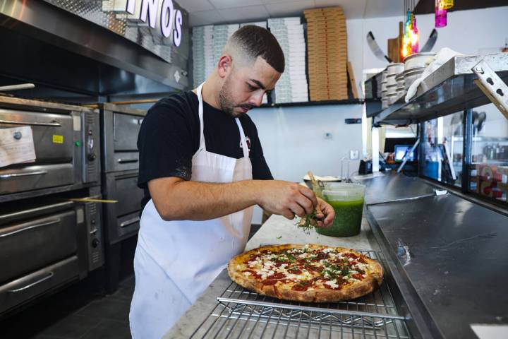 Owner Joey Scolaro prepares the Upside Down Pizza at Lucino’s pizza in Las Vegas, Thursd ...