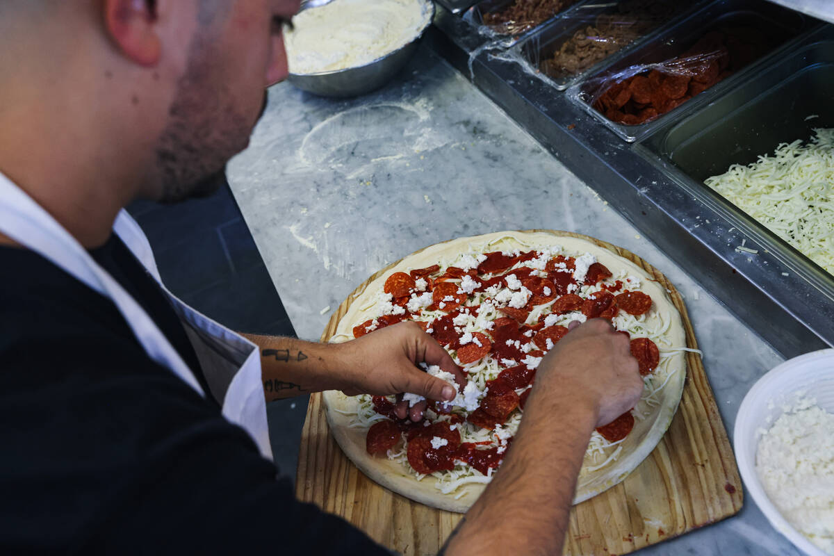 Owner Joey Scolaro prepares the Upside Down Pizza at Lucino’s Pizza in Las Vegas, Thursday, S ...