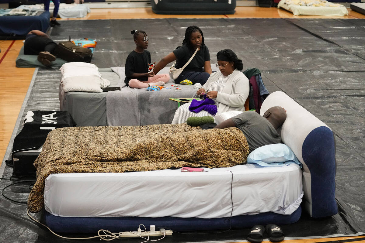 Sharonda and Victor Davis, of Tallahassee, sit with their children Victoria background left, an ...