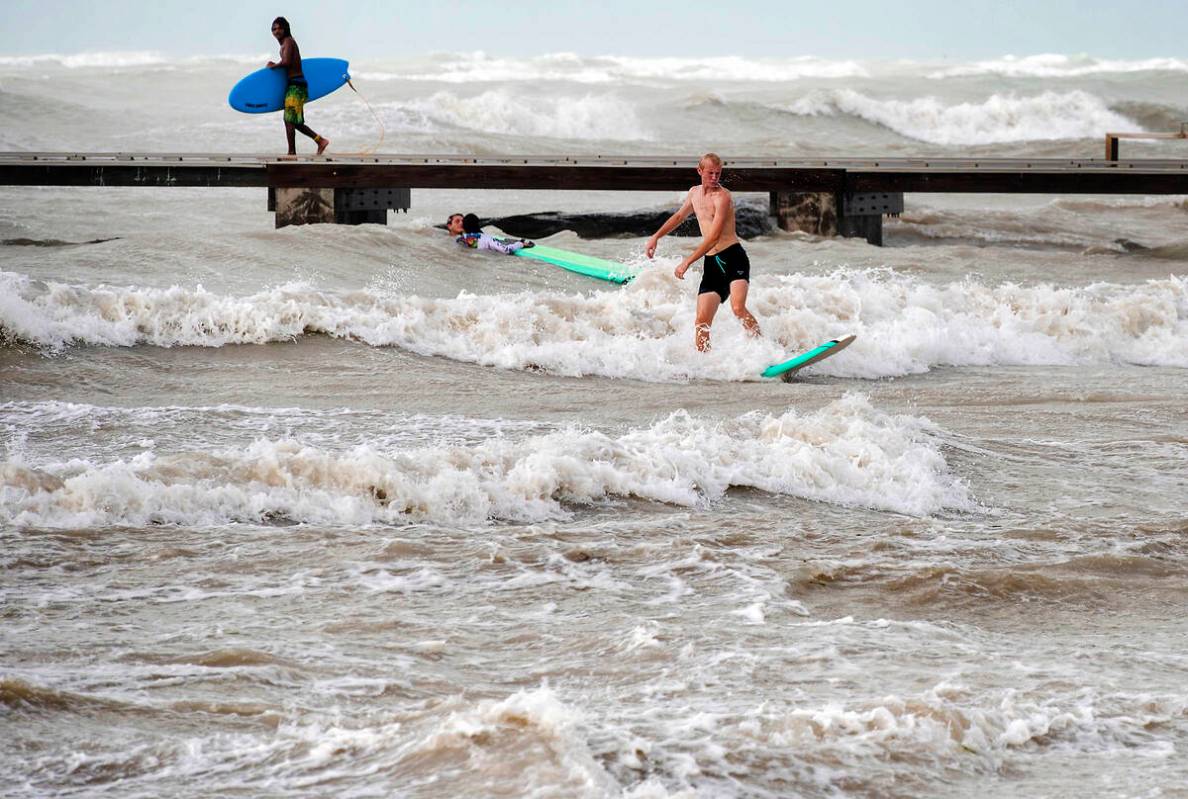 Surfers take advantage of heavy winds along Higgs Beach in Key West, Florida, on Thursday, Sept ...