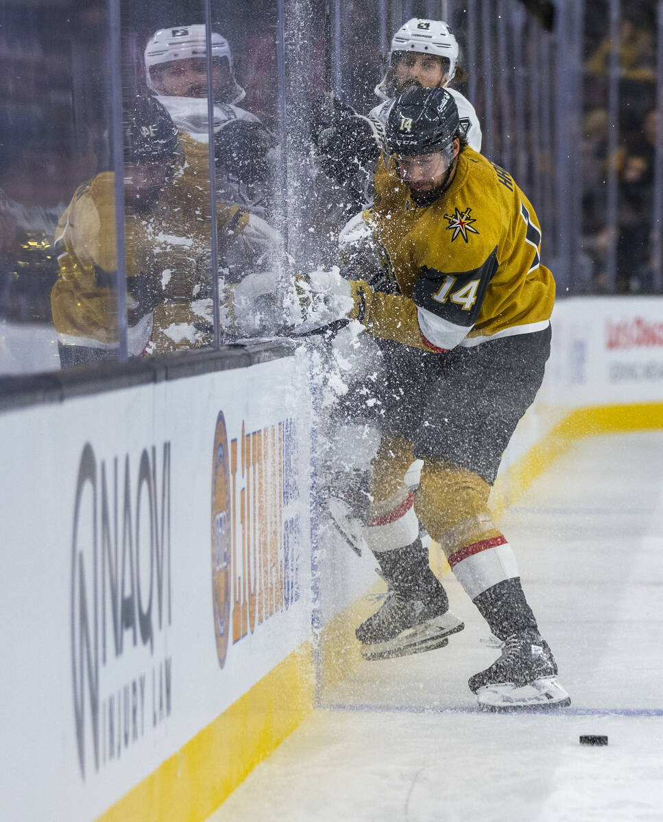 Golden Knights defenseman Nicolas Hague (14) catches the boards with Los Angeles Kings center P ...