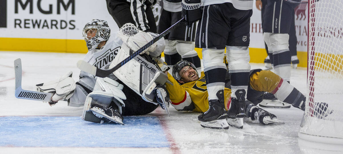 Golden Knights center Tanner Laczynski (28) takes out Los Angeles Kings goaltender Darcy Kuempe ...