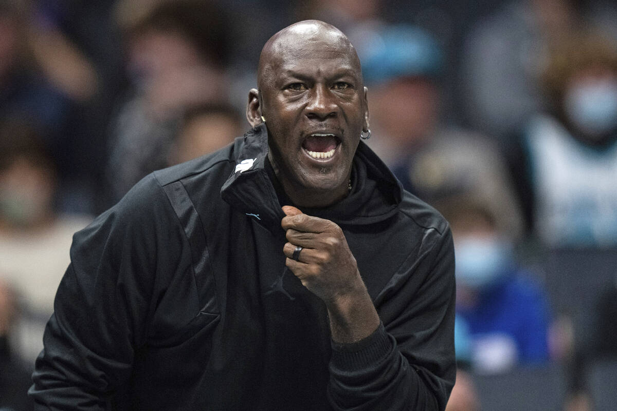 FILE - Michael Jordan looks on during the first half of an NBA basketball game between the Char ...