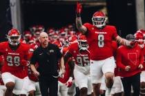 UNLV players run out of the tunnel during the Mountain West championship game at Allegiant Stad ...