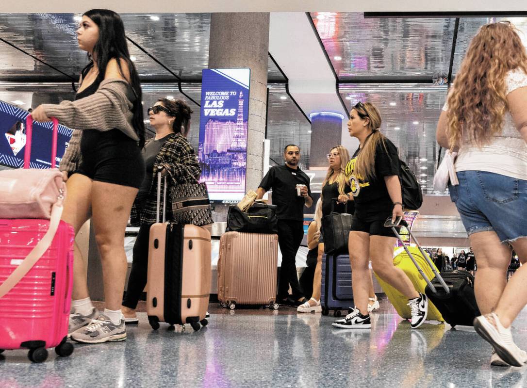 Arriving passengers head to baggage claim area at Terminal 1 of Harry Reid International Airpor ...