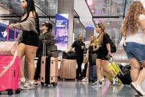 Arriving passengers head to baggage claim area at Terminal 1 of Harry Reid International Airpor ...