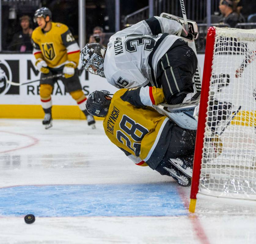 Golden Knights center Tanner Laczynski (28) takes out Los Angeles Kings goaltender Darcy Kuempe ...