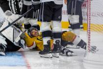 Golden Knights center Tanner Laczynski (28) takes out Los Angeles Kings goaltender Darcy Kuempe ...