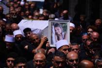 Israeli Druze mourners gathered for the funeral of the 12 children and teens killed in a Hezbol ...