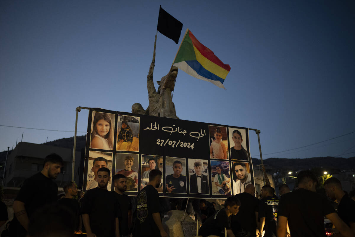 Photos of the children and teens killed in a rocket strike at a soccer field, are displayed at ...