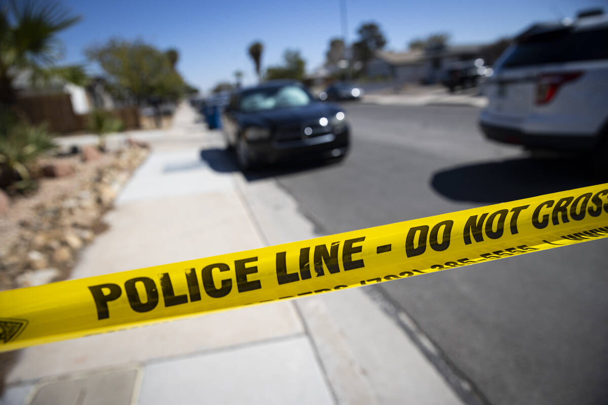 Police tape is seen as Las Vegas police investigate a homicide on the 6400 block of Placer Driv ...