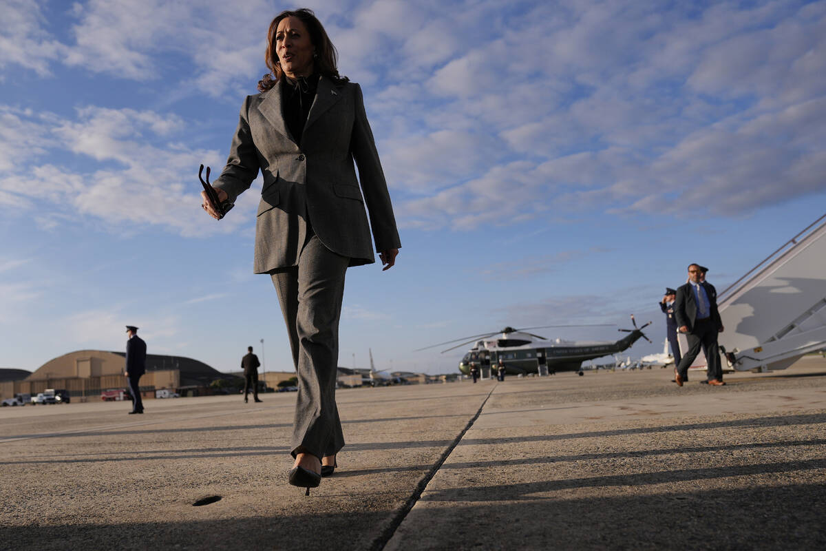 Democratic presidential nominee Vice President Kamala Harris walks over to speak to members of ...