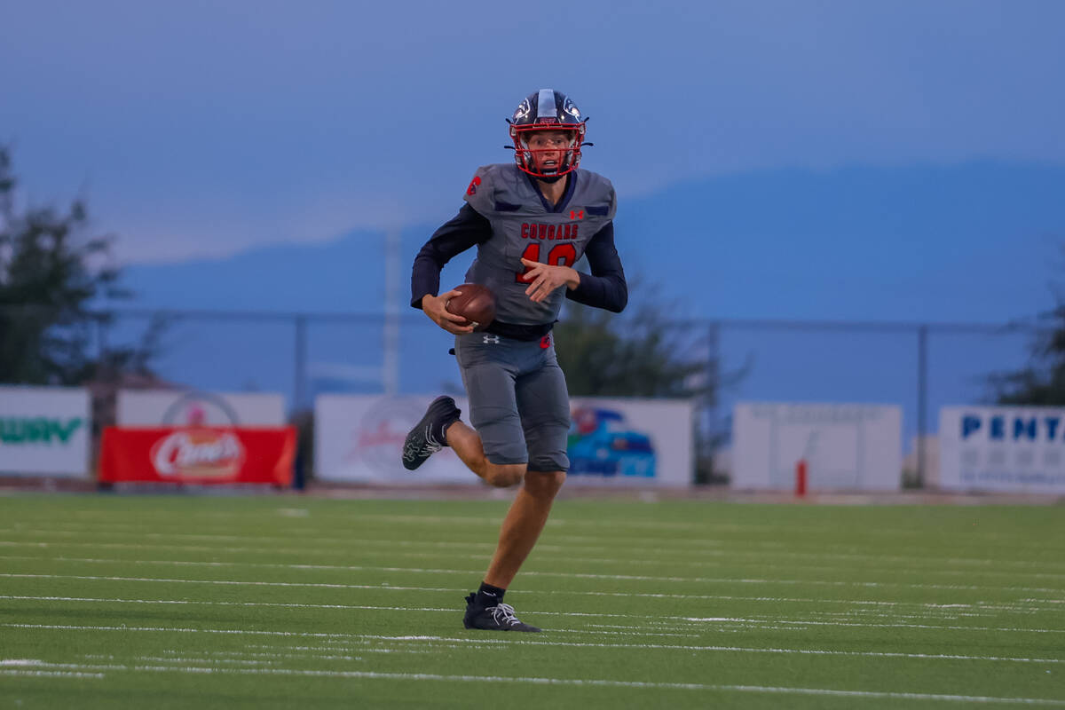 Coronado Quarterback Aiden Krause (10) runs out of the pocket for a gain during a football game ...