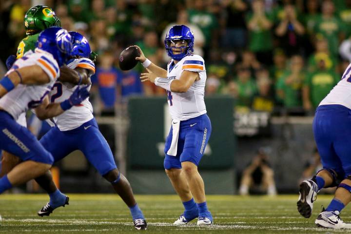 Boise State quarterback Maddux Madsen, center, looks to pass during the first half of an NCAA c ...