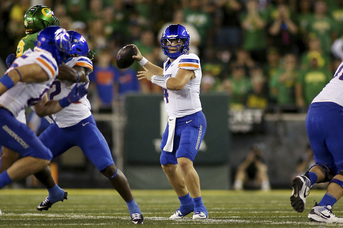 Boise State quarterback Maddux Madsen, center, looks to pass during the first half of an NCAA c ...