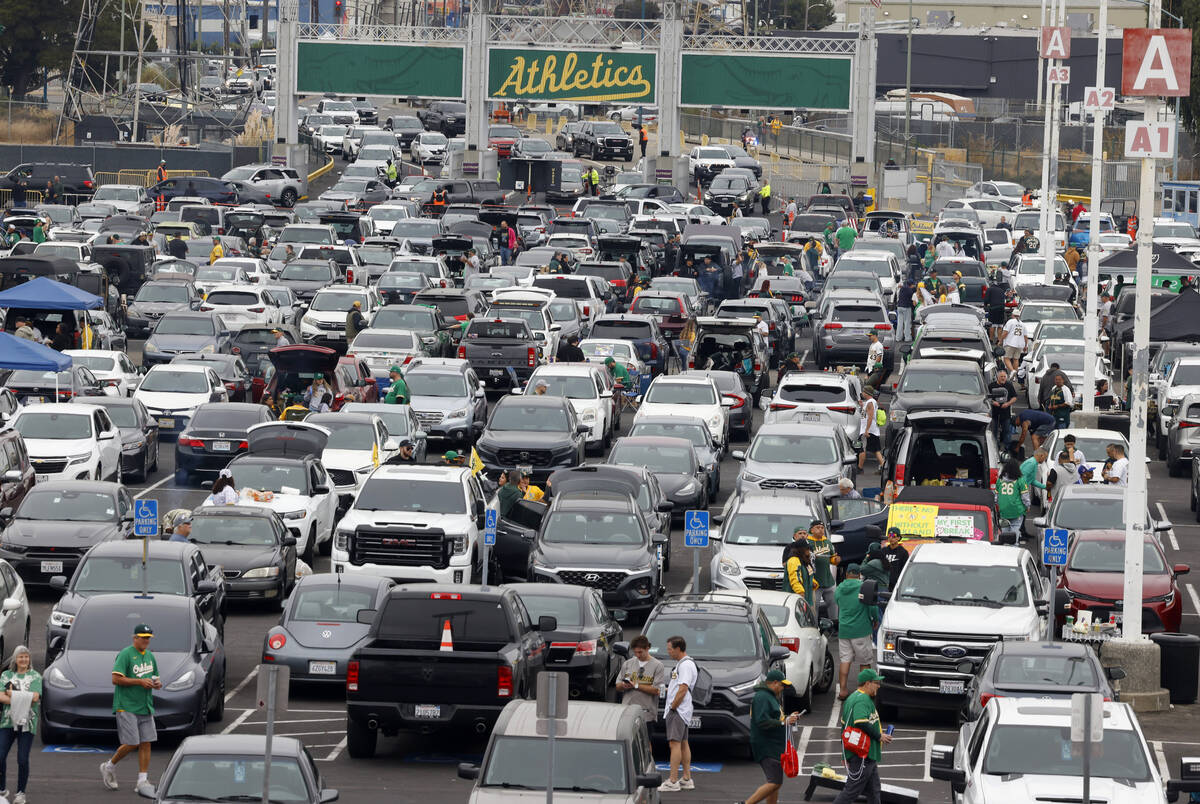 Fans tailgate at Oakland Coliseum before Oakland Athletics final home game against the Texas Ra ...