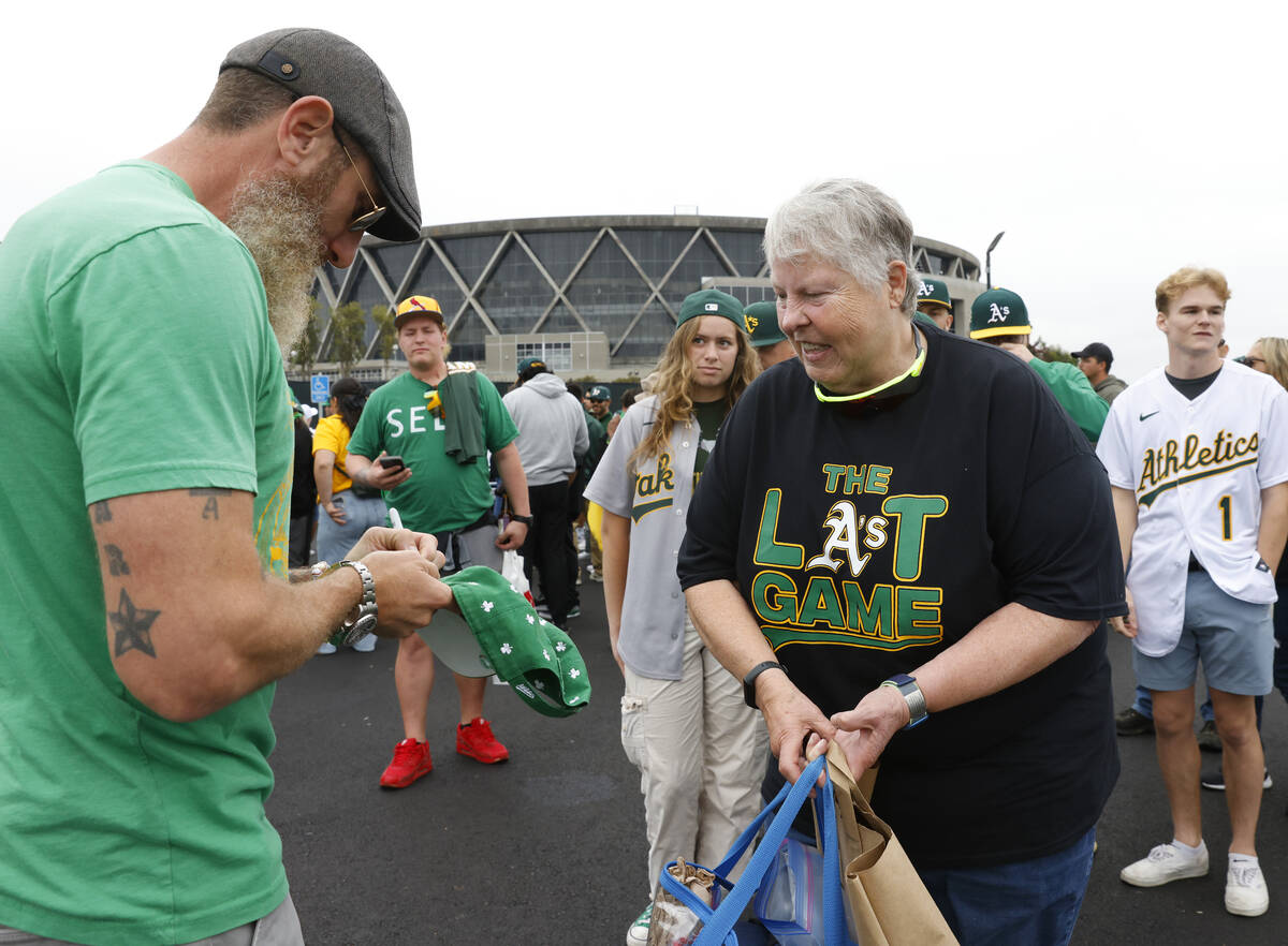 Former Oakland Athletics pitcher Dallas Braden signs an autograph for Charlotte Scannell outsid ...