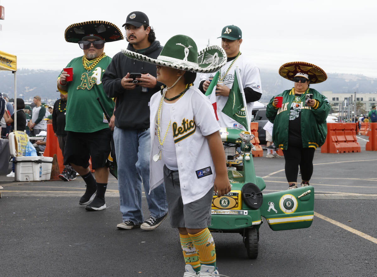 Fans, including Cruz Munoz, 8, arrive to attend Oakland Athletics final home game against the T ...