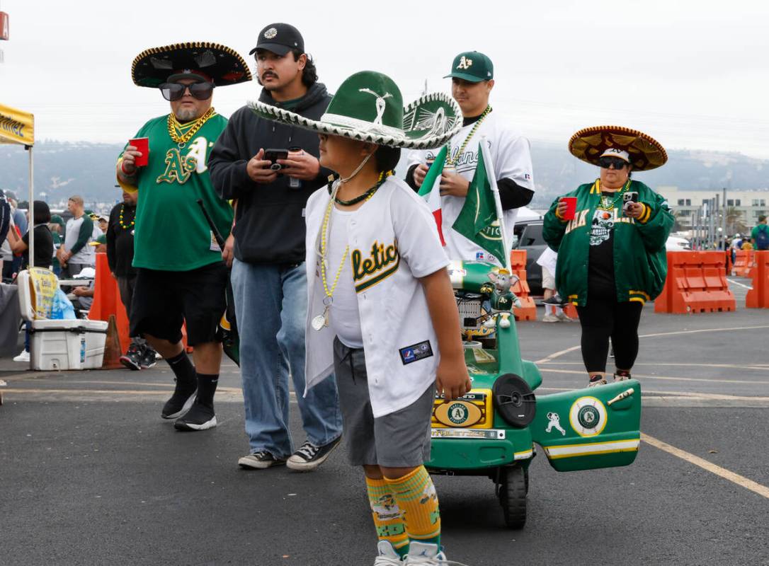 Fans, including Cruz Munoz, 8, arrive to attend Oakland Athletics final home game against the T ...