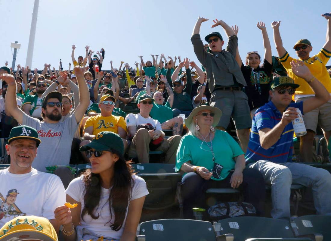 Oakland Athletics fans cheer during the final home game against the Texas Rangers at Oakland Co ...