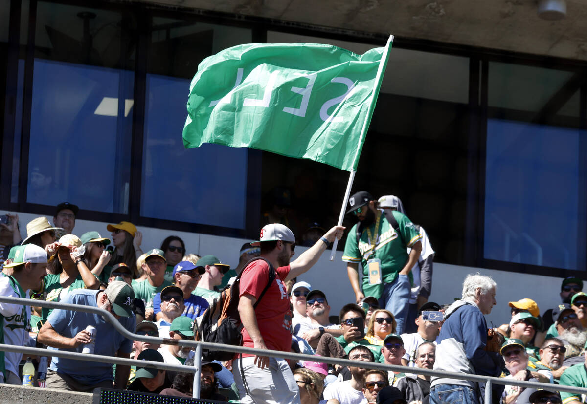 An Oakland Athletics fan waves "Sell" flag during the final home game against the Tex ...